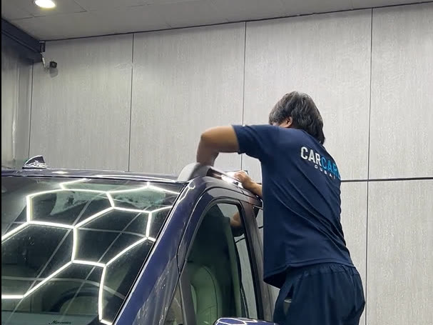 CarCare Dubai technician detailing a customer's car for the Pick & Drop Wash service